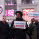 Members of MoveOn.org Political Action stand outside the studios of ‘Good Morning America’ to broadcast messages of love, dignity, and equality and stand up against the hate, racism, and incitement of violence that the group says has become a hallmark of Donald Trump’s presidential campaign, March 16, 2016, in New York City.